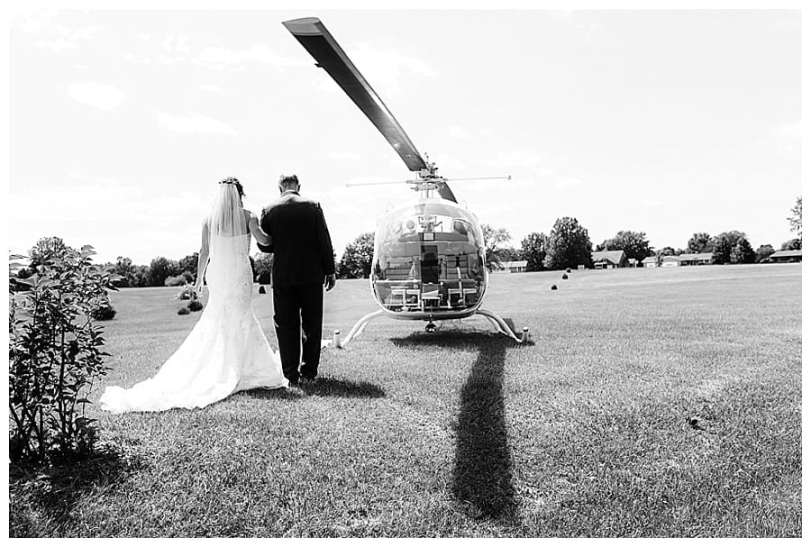 father walking bride to helicopter