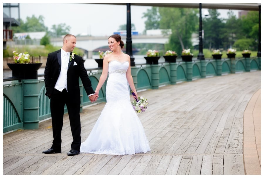 bride and groom by river at the lansing center