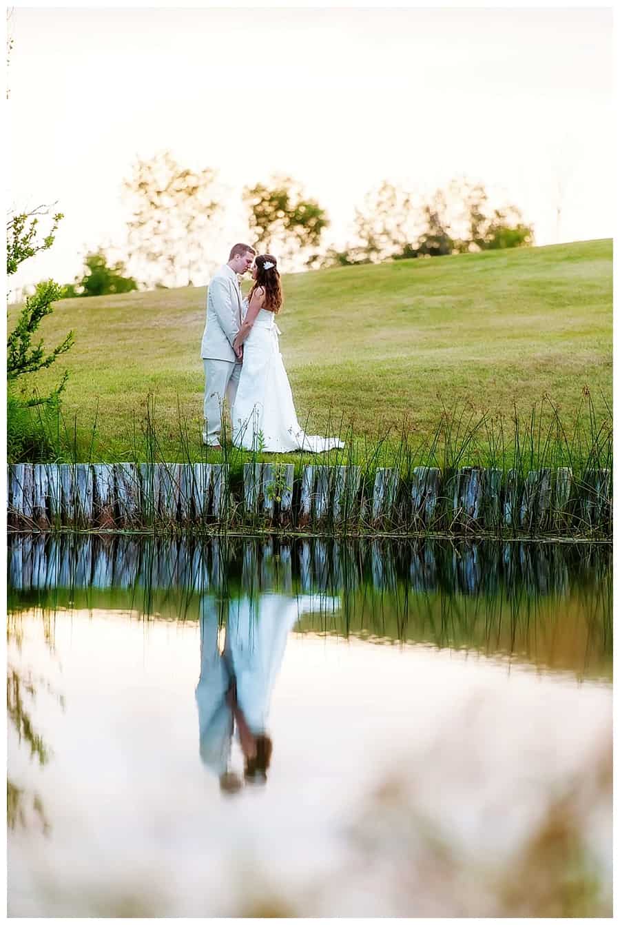 bride and groom on pond