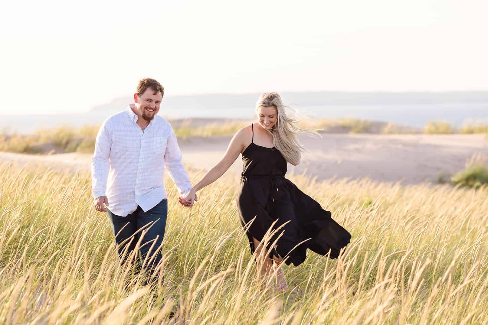 engagement session in dune grass and sand dunes