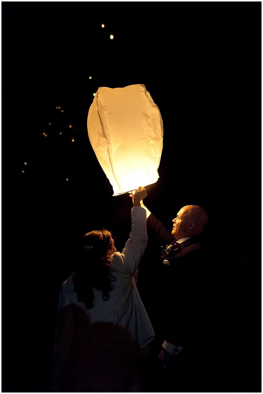 Bride and Groom releasing a Chinese lantern at their wedding reception