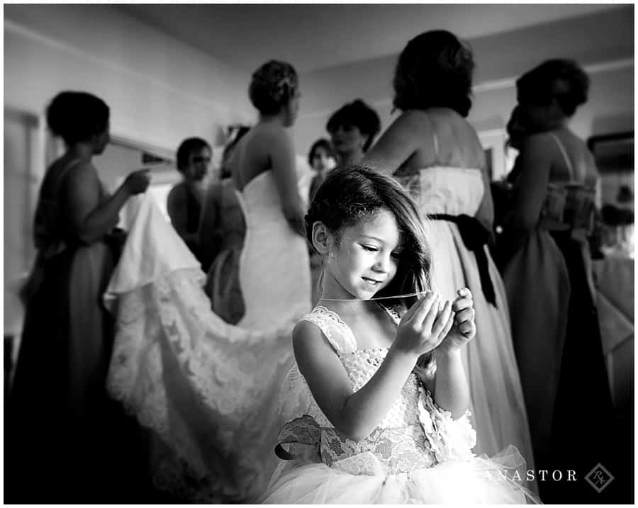Little Girl excited over necklace given to her by the bride.