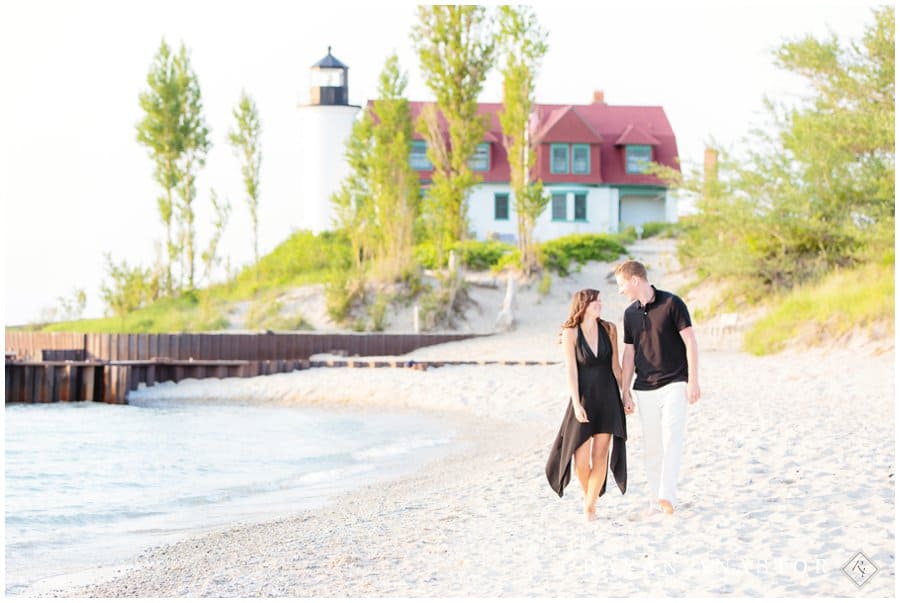 couple walking the beach at point betsie lighthouse
