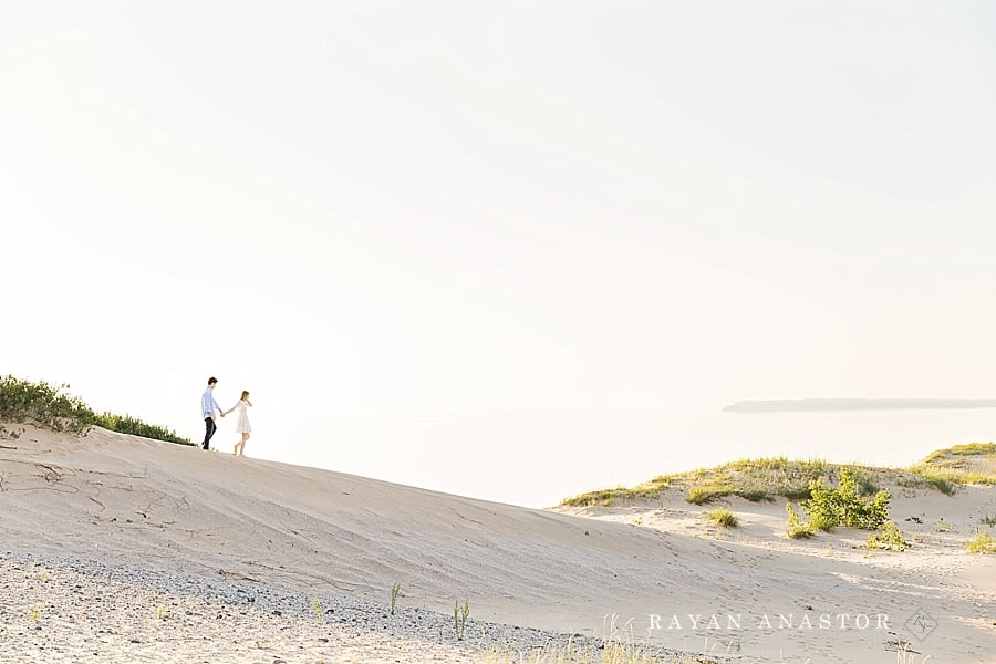 Engagement photo at Sleeping Bear Dunes overlooking lake michigan and the manitou islands