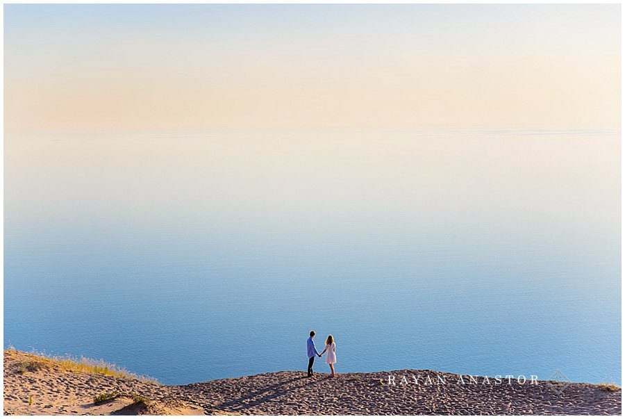 Couple enjoying the sunset on Sleeping Bear Dunes at Lake Michigan