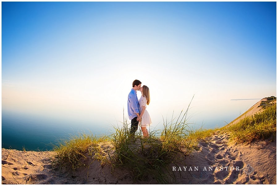 engagement photo in sand dunes overlooking lake michigan