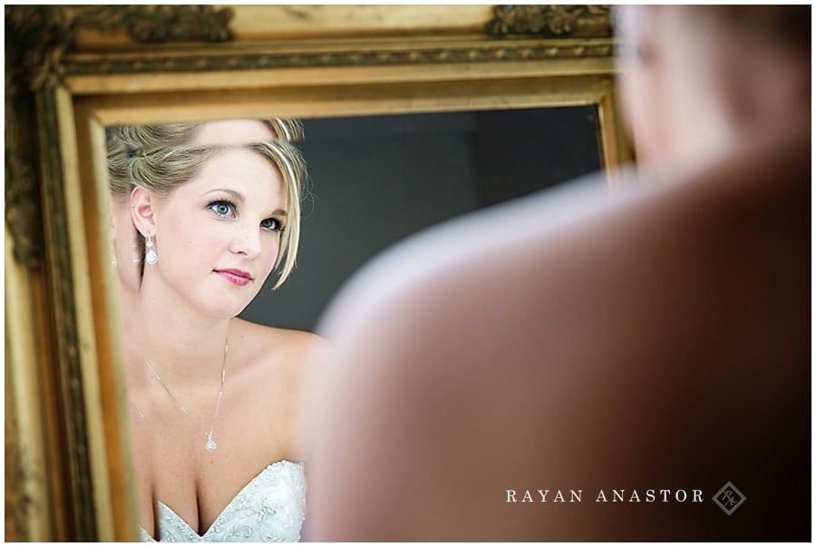 bride doing final touch ups before wedding
