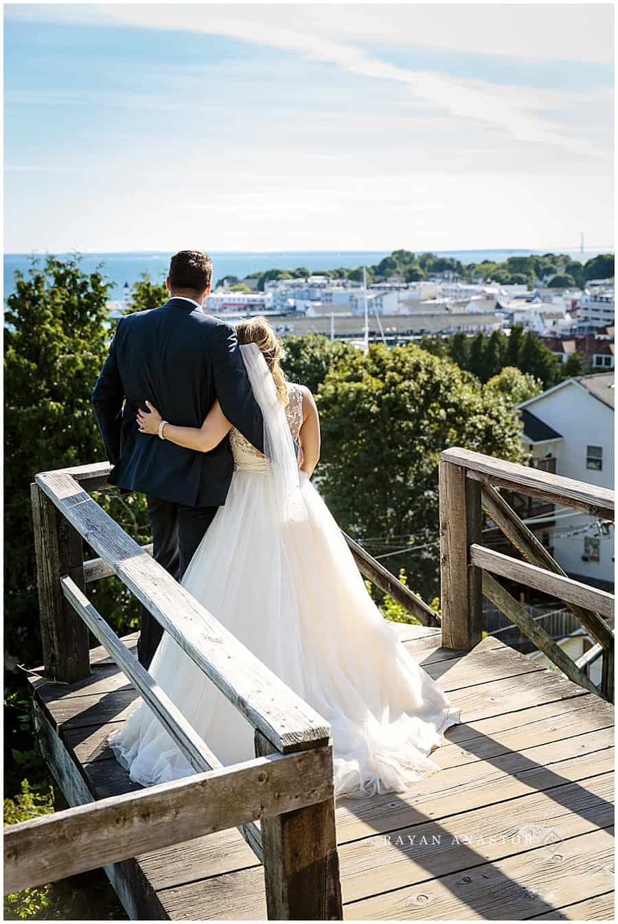 bride and groom viewing mackinac island