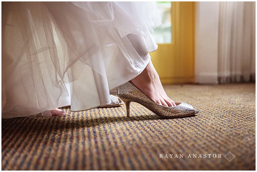 bride putting on jimmy choo shoes