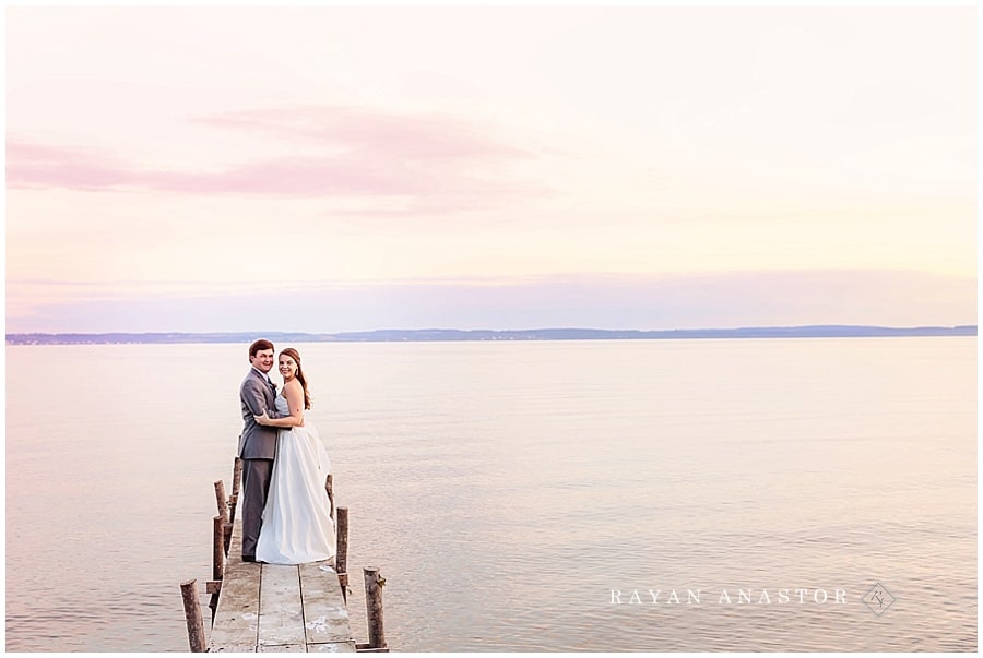 bride and groom on lake michigan at sunset in harbor springs