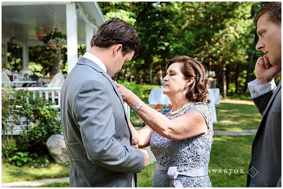 mom putting on sons boutonnière