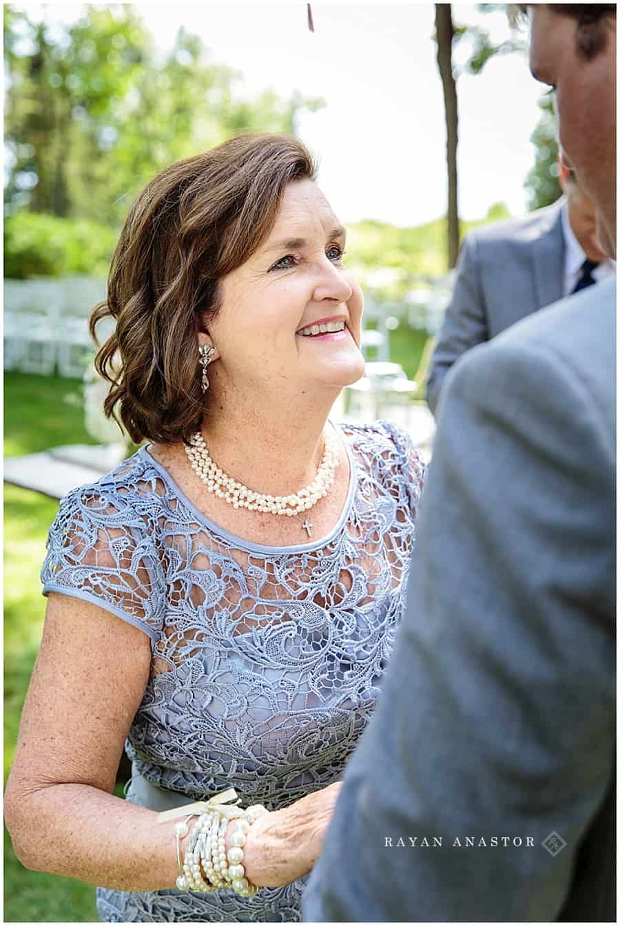 mom smiling at son before wedding