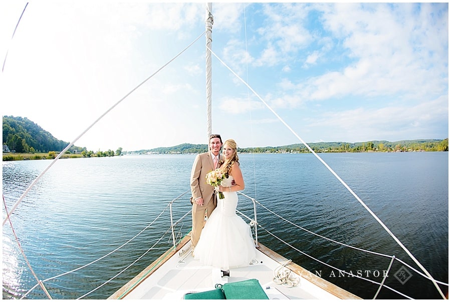 bride and groom on sail boat after wedding