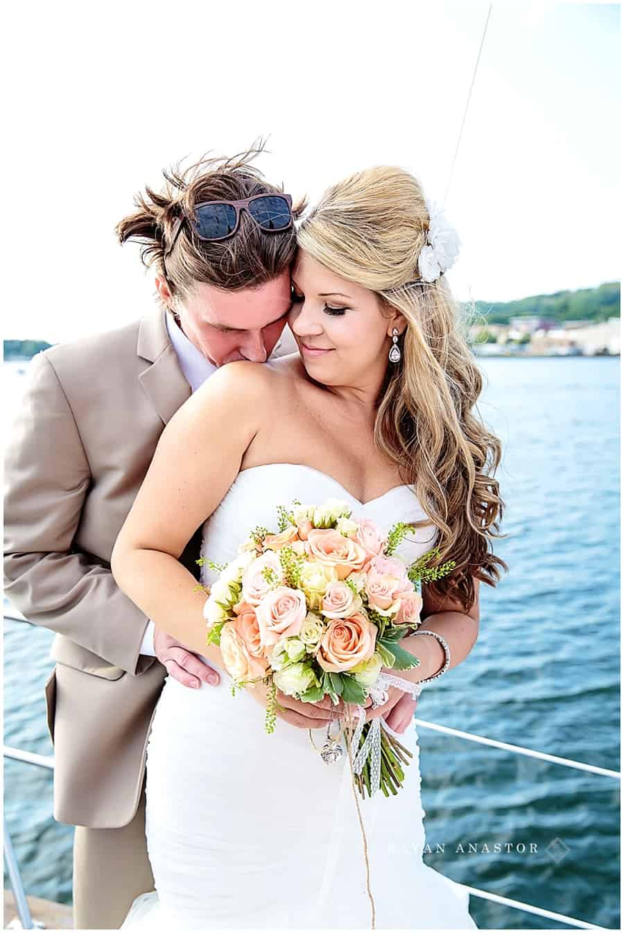 bride and groom on sail boat after wedding