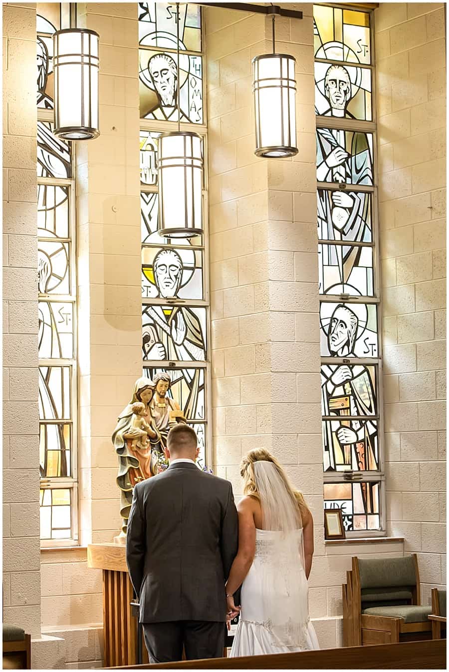 bride and groom during catholic ceremony