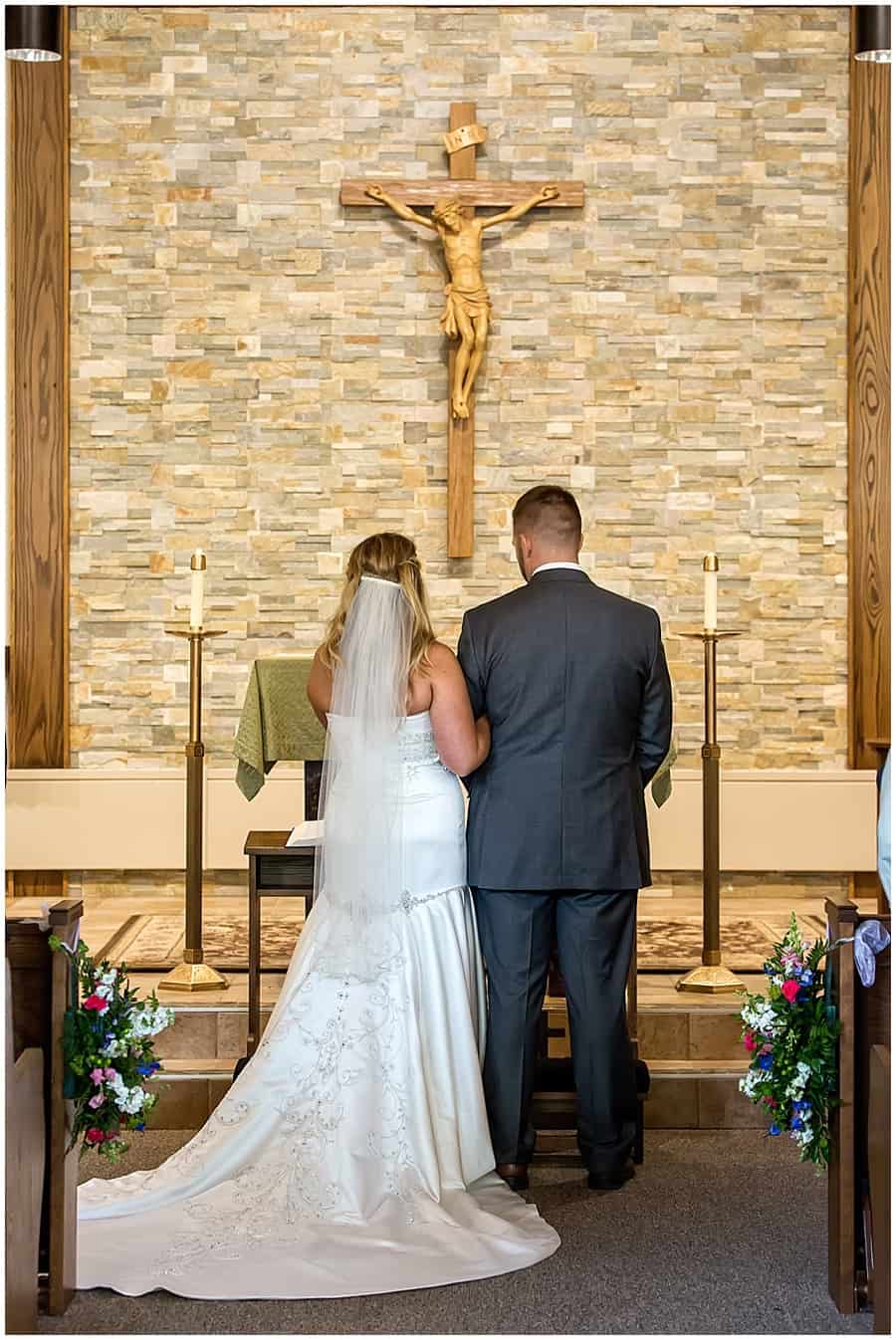 bride and groom during catholic ceremony