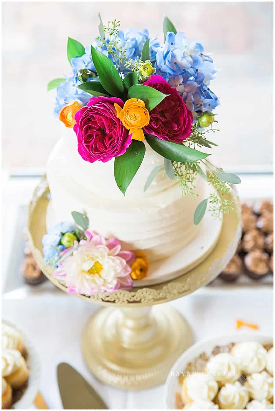 white wedding cake with flowers in harbor springs