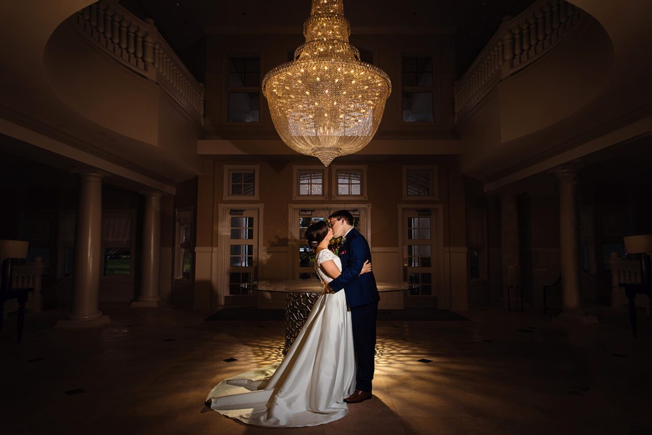 Inn at Bay Harbor Portrait of Bride and Groom in Grand Entrance with Chandelier
