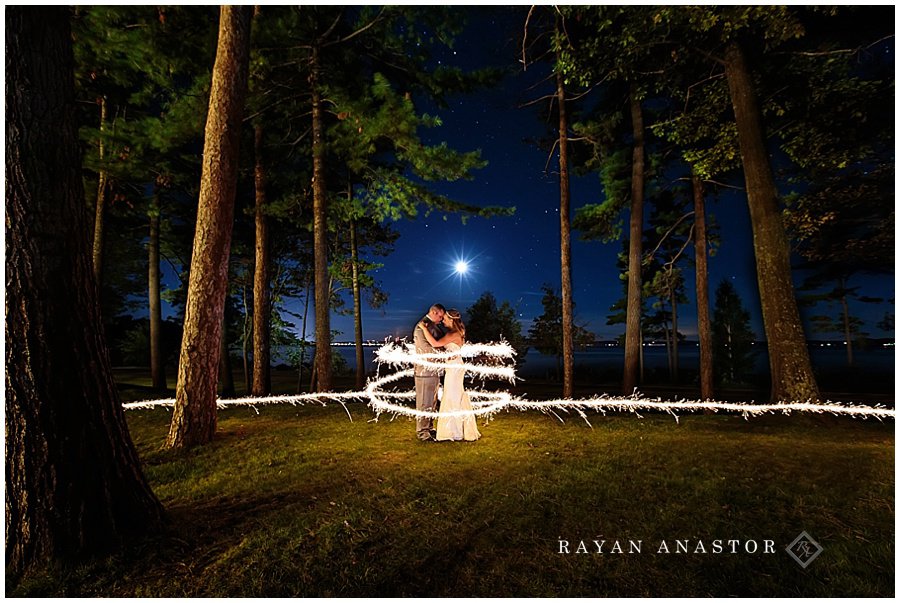 sparkler photo during full moon in traverse city on west bay