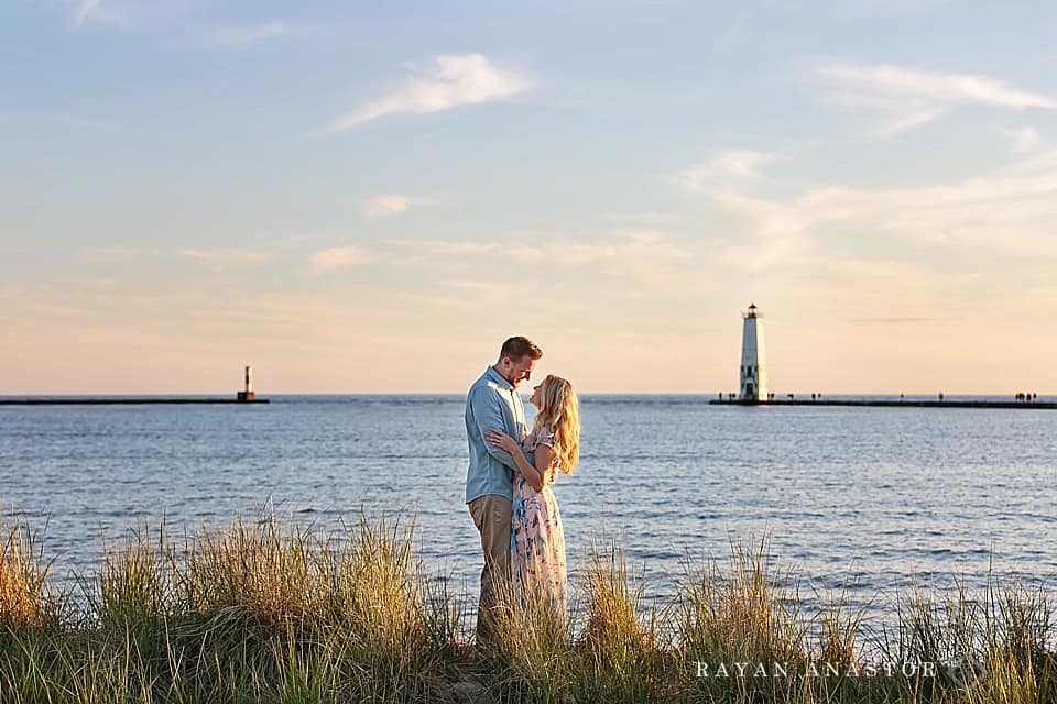 Engagement photos on lake michigan with lighthouse