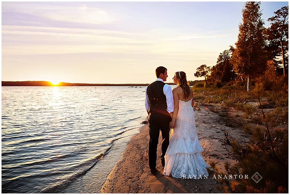 sunset walk on west grand traverse bay for bride and groom