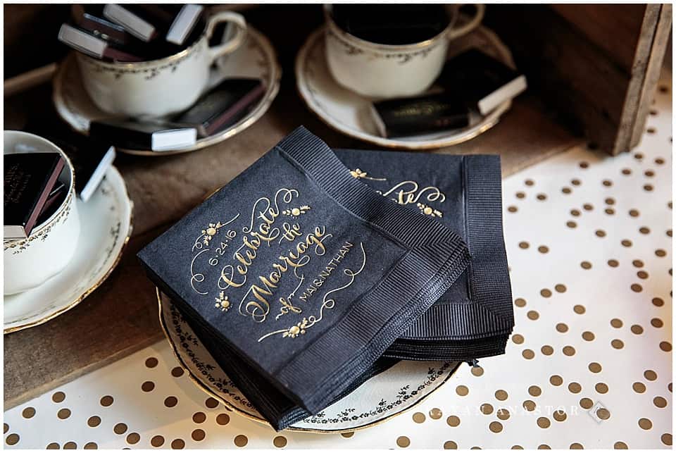 black napkins with gold letting for wedding