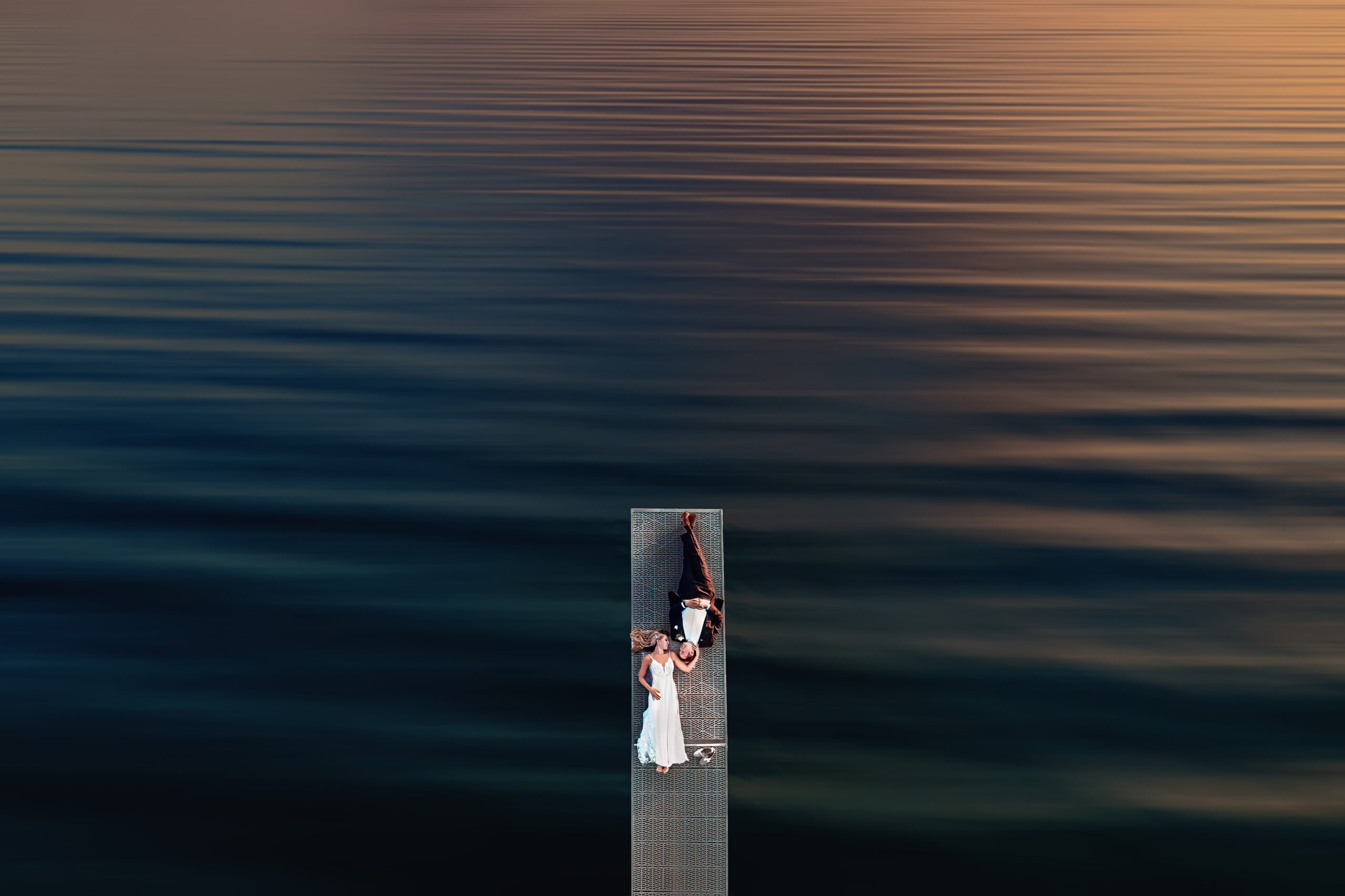 sunset photo of couple on dock from drone