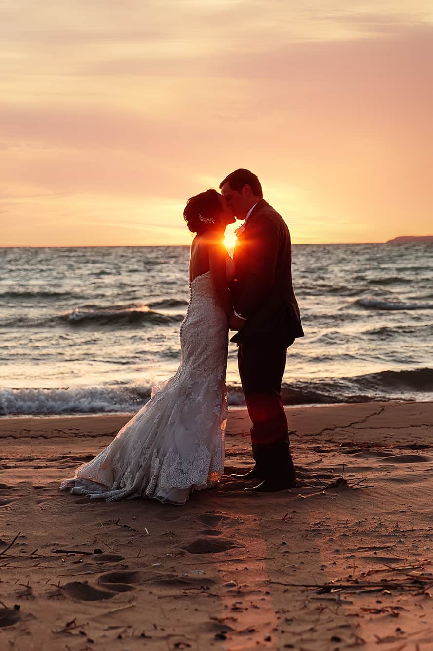 couple at sunset on Lake Michigan at the Homestead