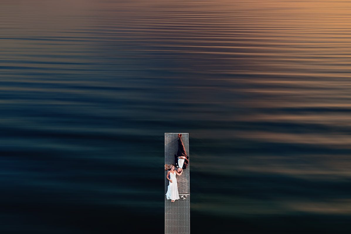 bride and groom on dock on Lake Michigan