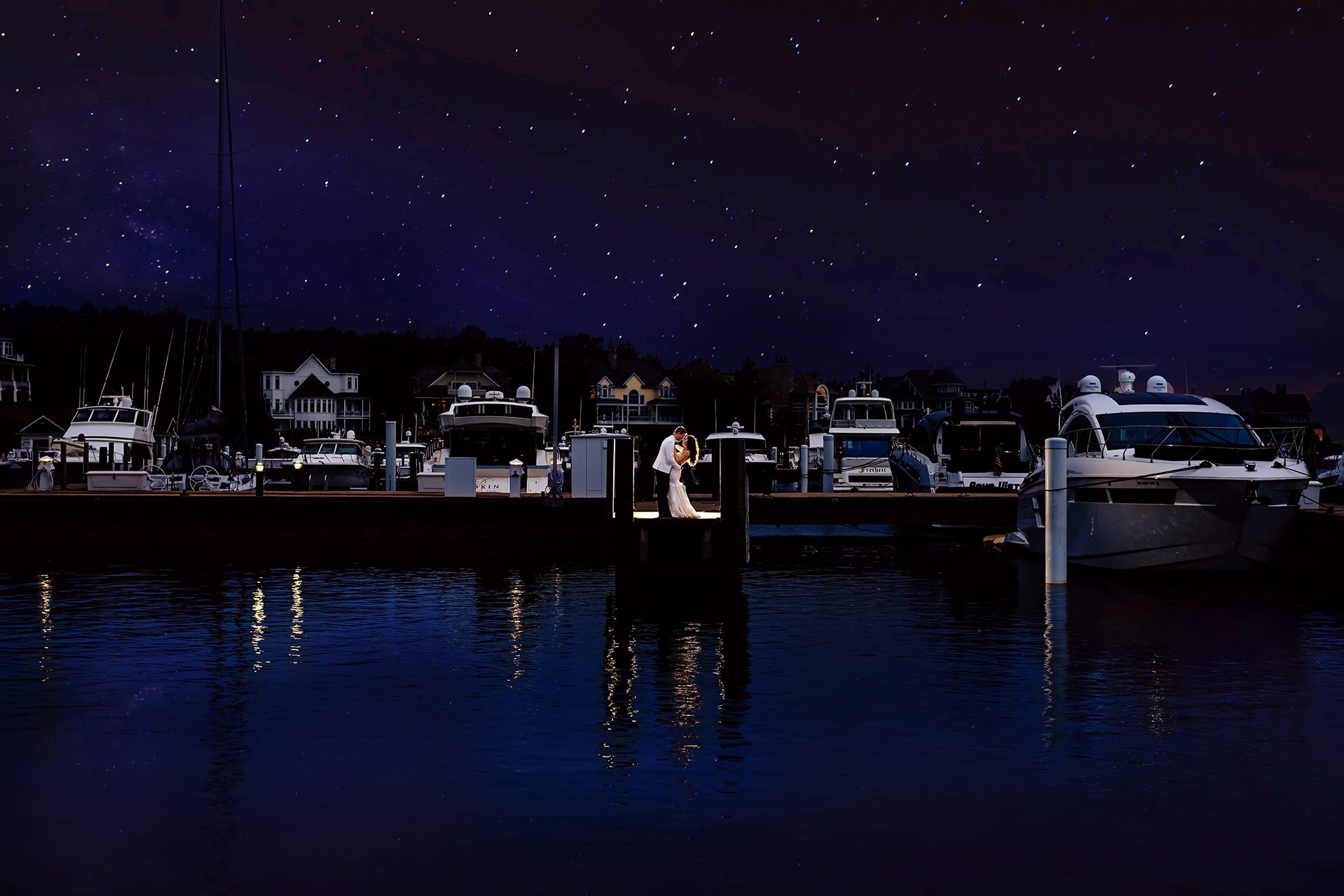 bride and groom on bay harbor yacht club docks at night