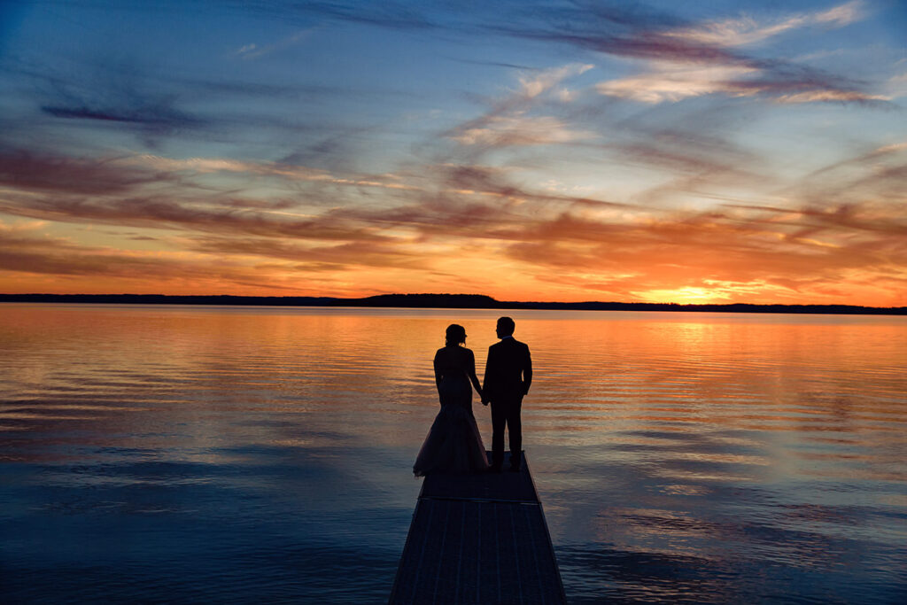 sunset portraits of bride and groom on Lake Michigan