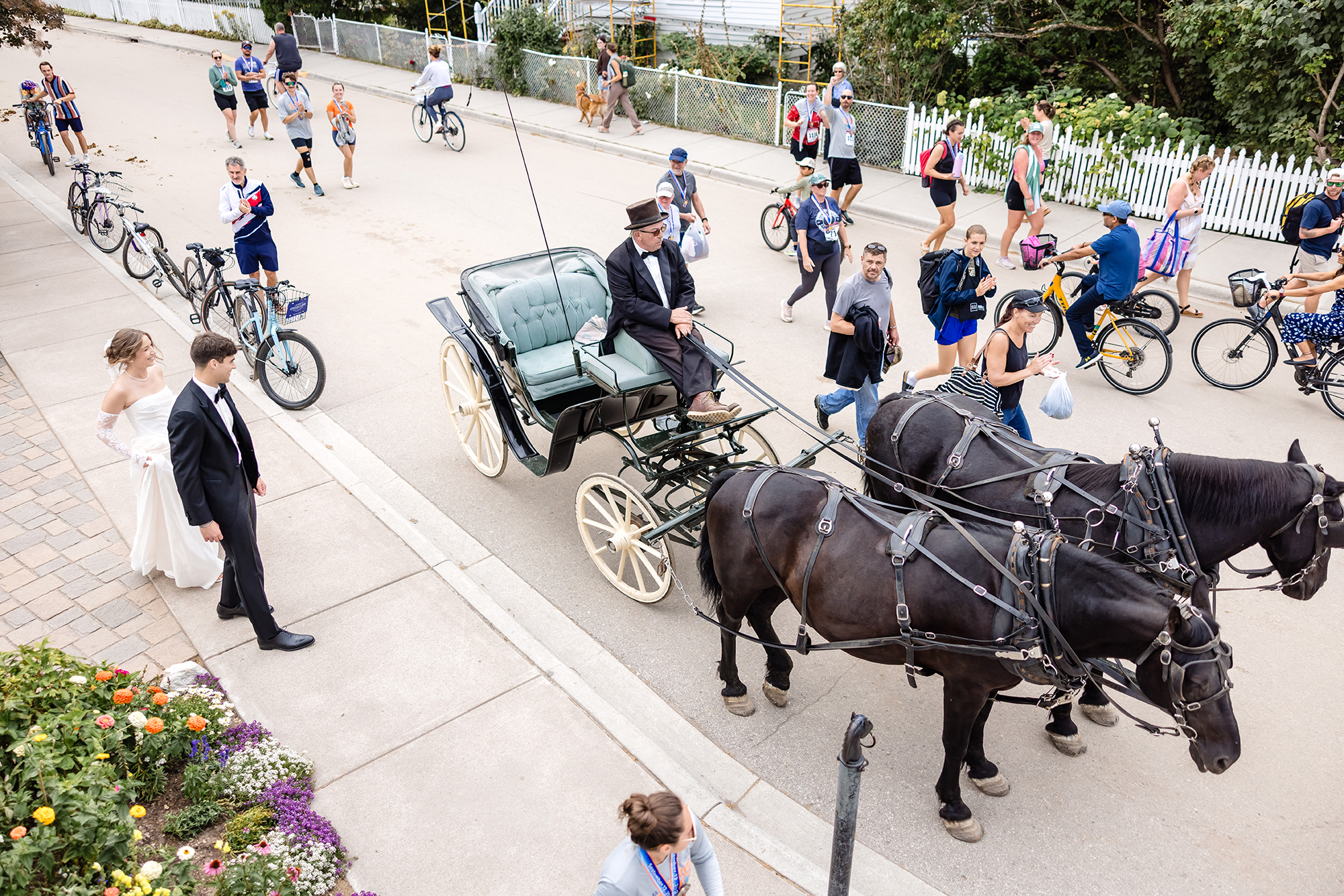 bride and groom getting in horse carriage at St. Anne's Church on Mackinac Island