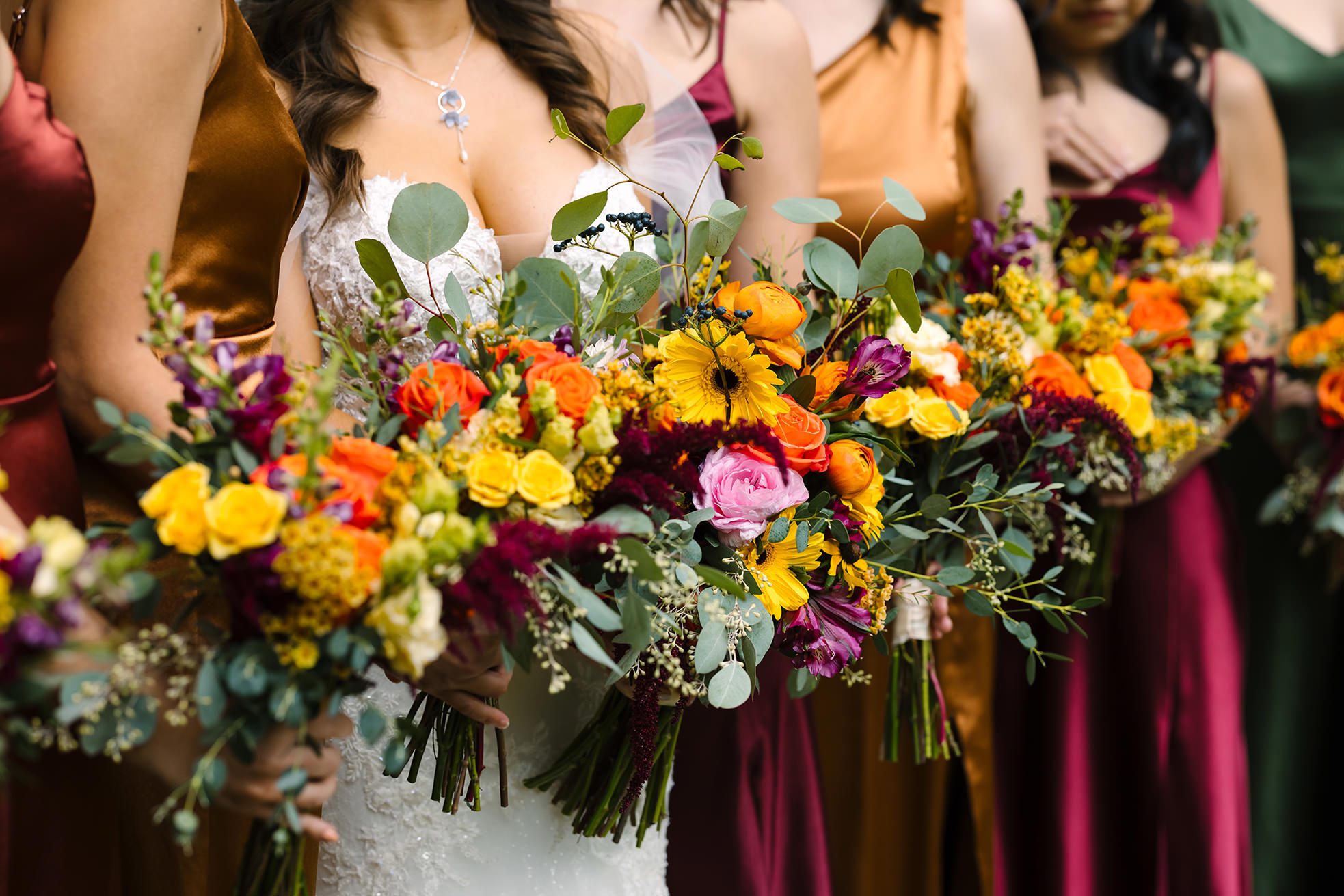 fall bridesmaids dressed and their florals