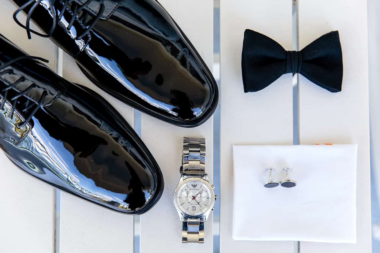 bowtie shoes watch and cufflinks of grooms at wedding black and white