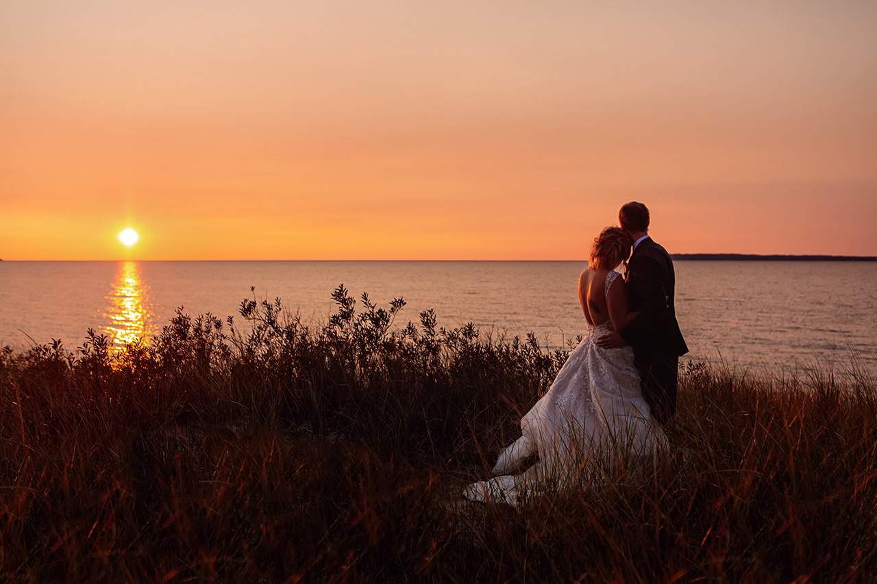 bride and groom on Lake Michigan at sunset