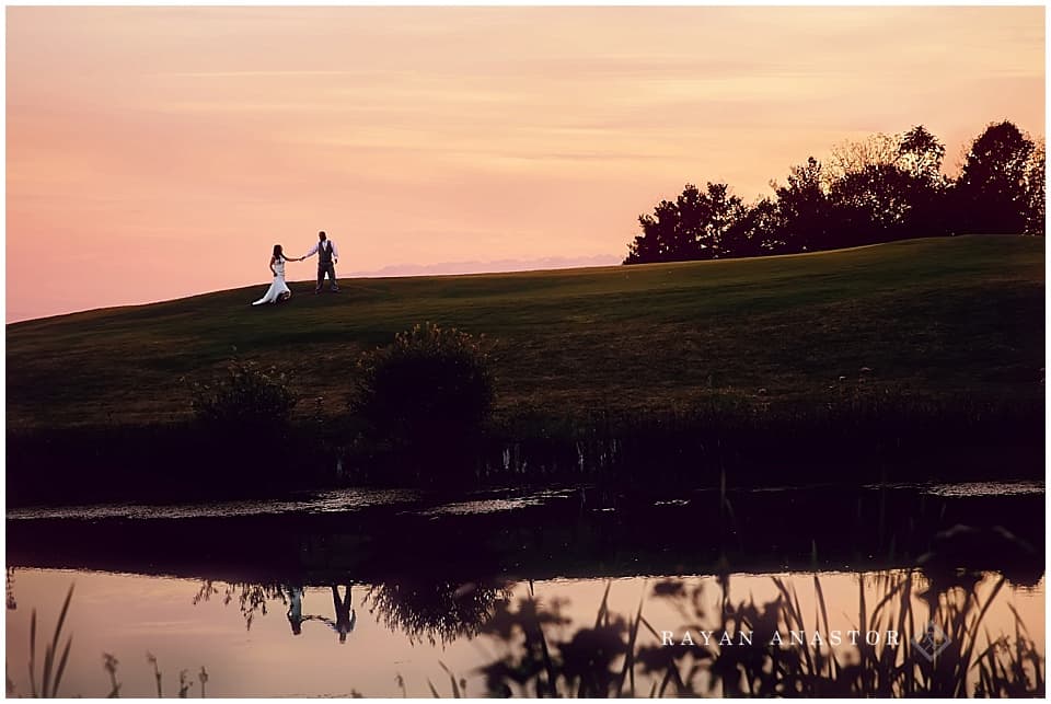 Bride and Groom talking a walk at sunset on golf course
