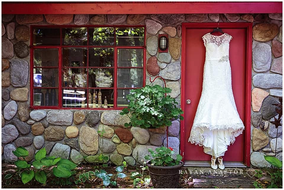 Wedding gown on red door of cottage