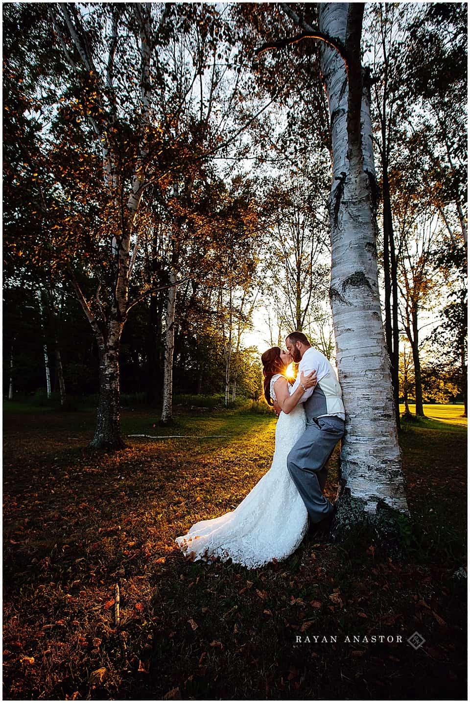 bride and groom in birch trees at sunset
