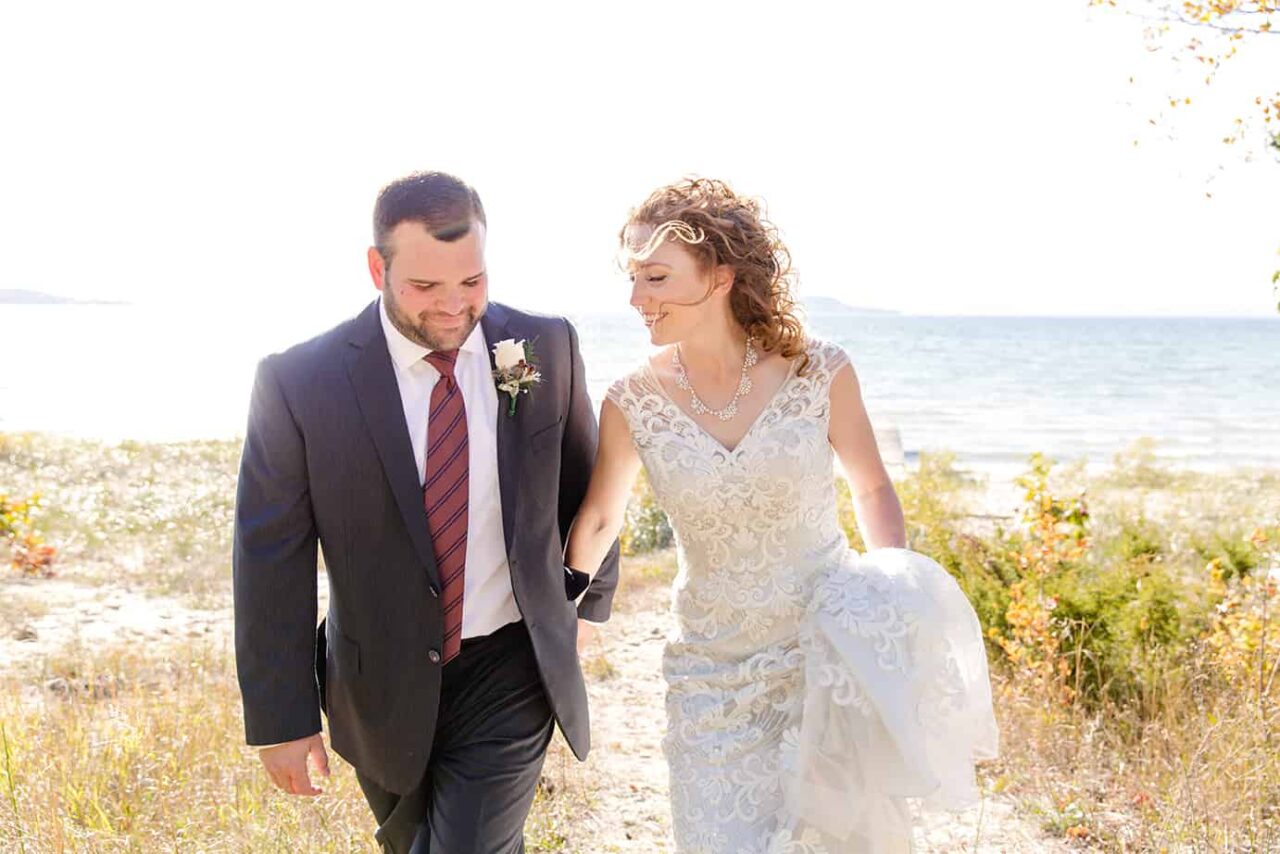 Bride and Groom at sunset on Lake Michigan in the fall