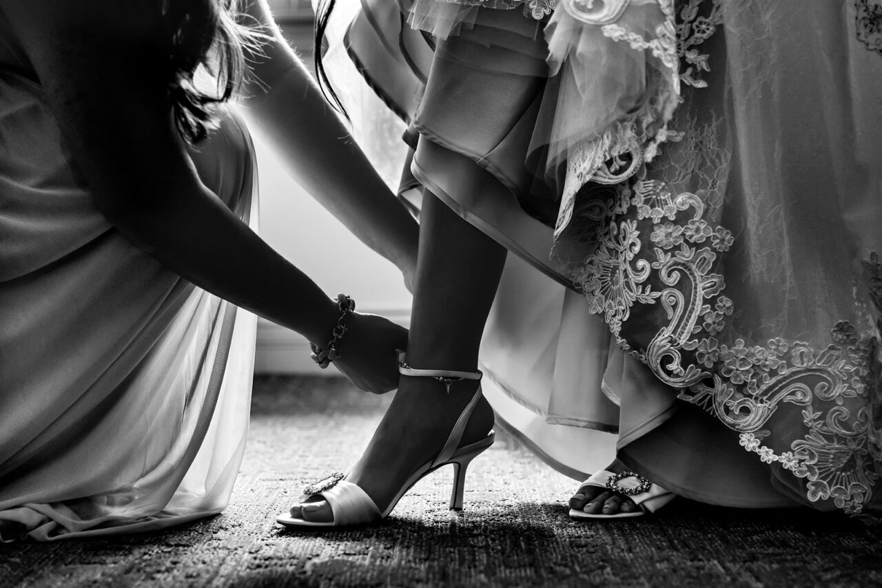 Bride putting on her wedding shoes