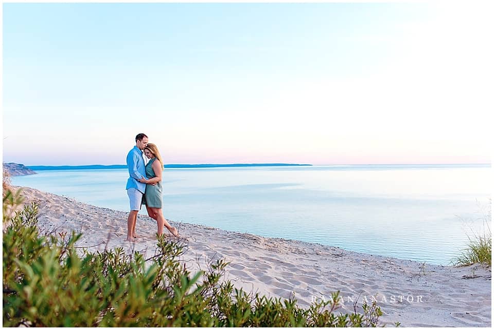 Engagement photo of couple at sunset on Lake Michigan