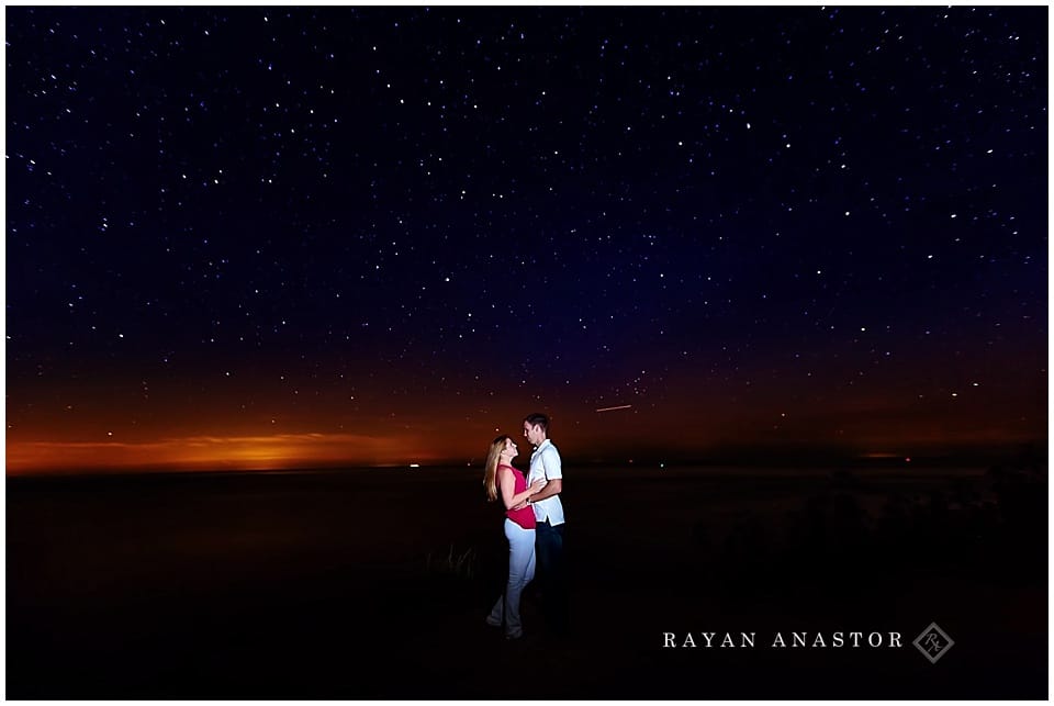 engagement photo at night with Lake Michigan and stars