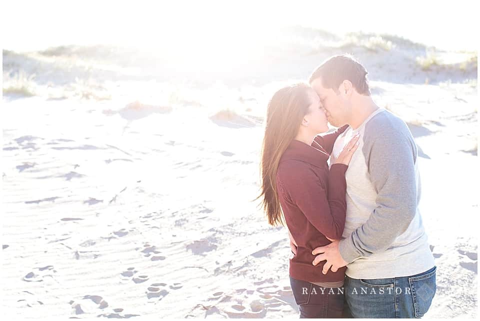 Engagement photos on sand dunes overlooking lake michigan