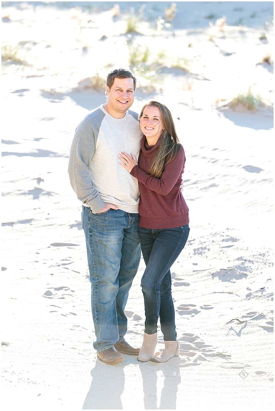 Engagement photos on sand dunes overlooking lake michigan