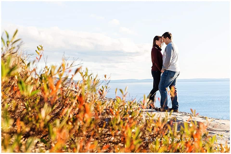 Engagement photos on sand dunes overlooking lake michigan
