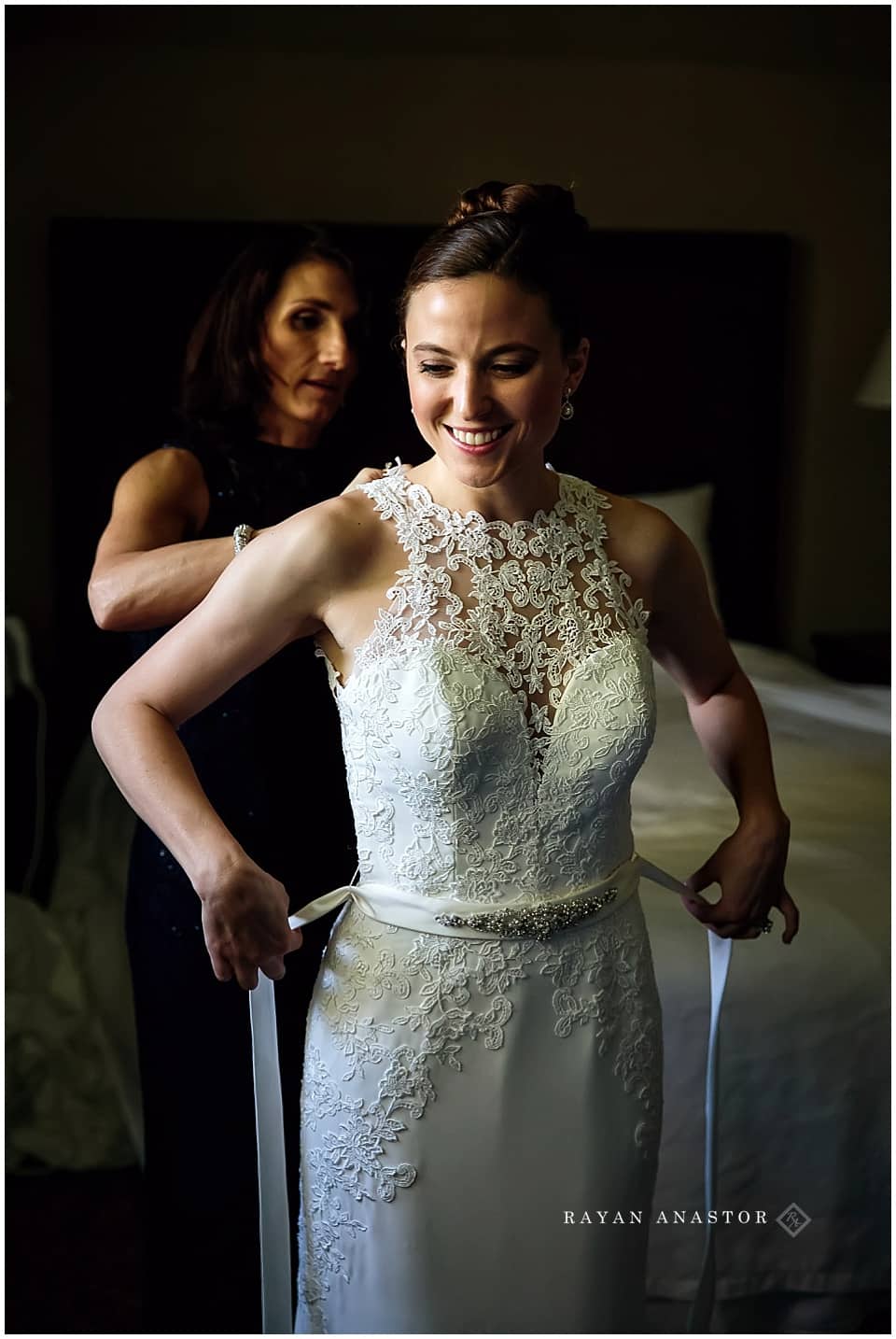 Bride getting dressed at Inn at Stonecliffe