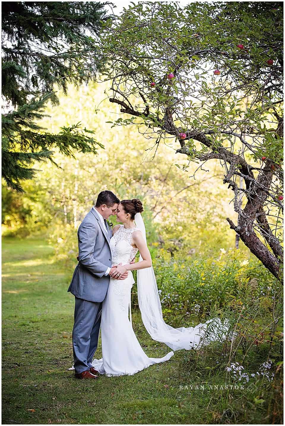 bride and groom portraits in the orchard at the inn at stonecliffe