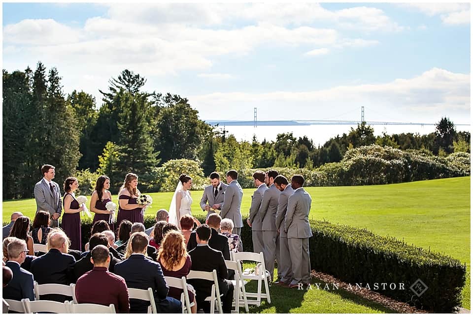 wedding on the lawn at the inn at stonecliffe overlooking the mackinac bridge