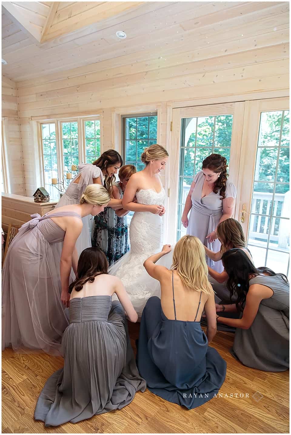 bride getting into her monique lhuiller wedding gown