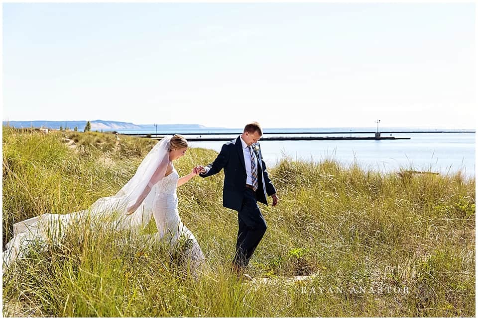 Monique Lhuiller Wedding gown with bride and groom in Frankfort on Lake Michigan